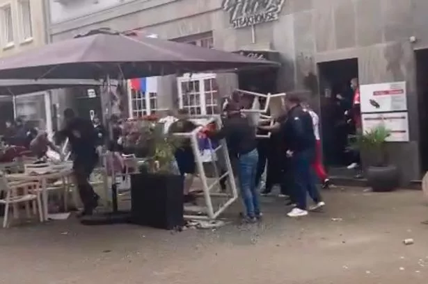 Bloke covered in blood as England and Serbia fans fight with tables and bottles in Germany